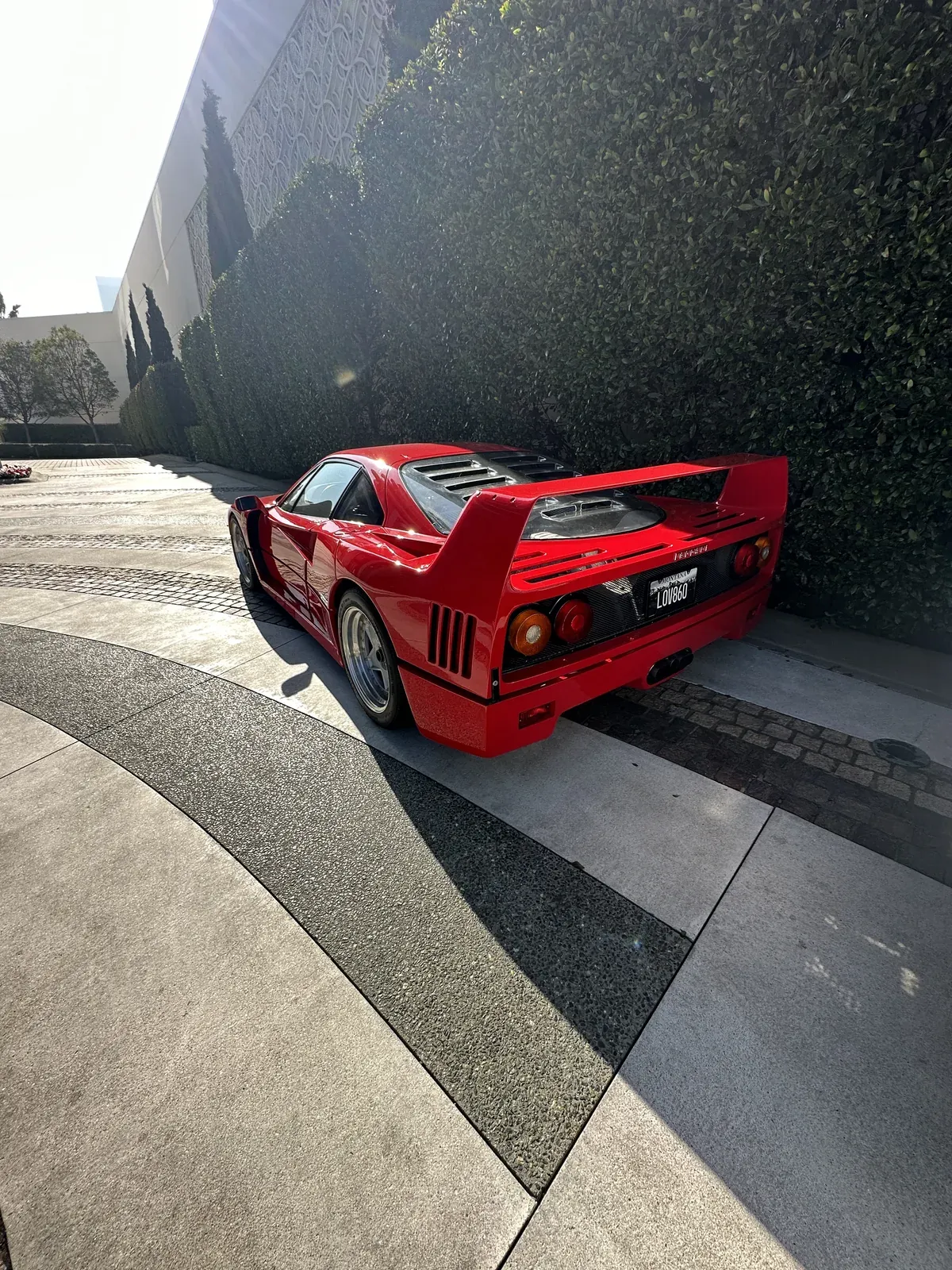Red Ferrari F40 rear three-quarter view showing detailed paintwork and clean wheels
