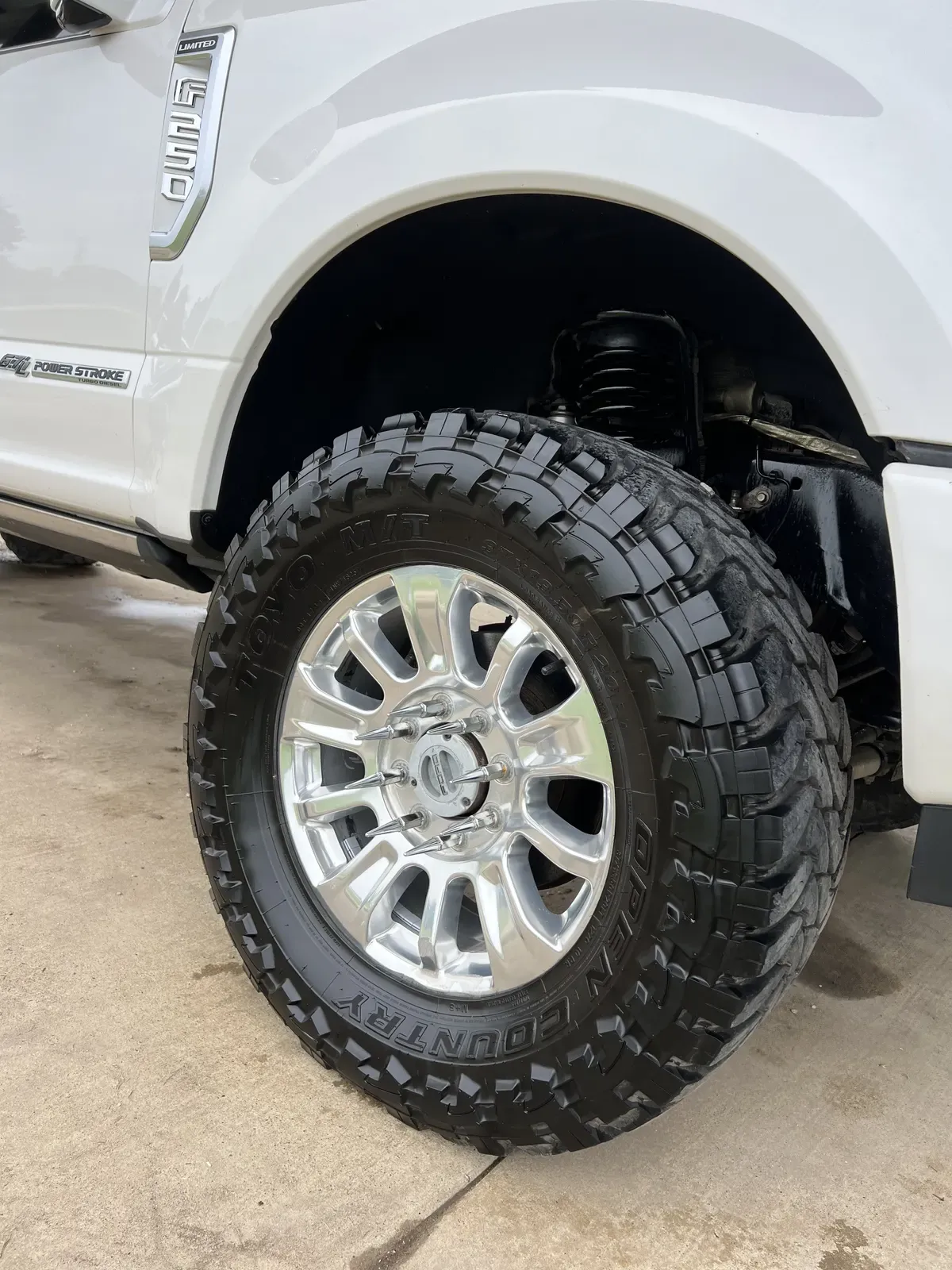 Polished bright wheel and dressed tire on a Ford F-250 Super Duty Limited after detailing