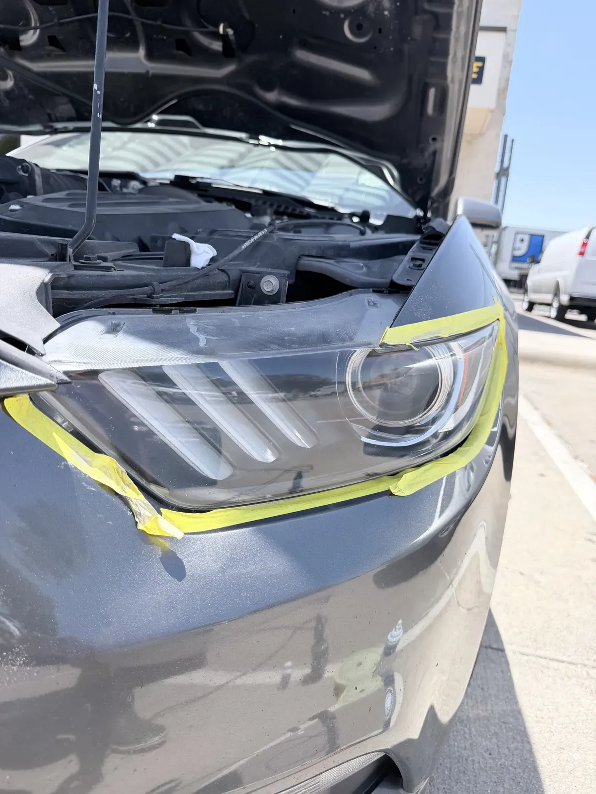 Ford Mustang headlight lens sanded to a uniform haze partway through progressive wet sanding