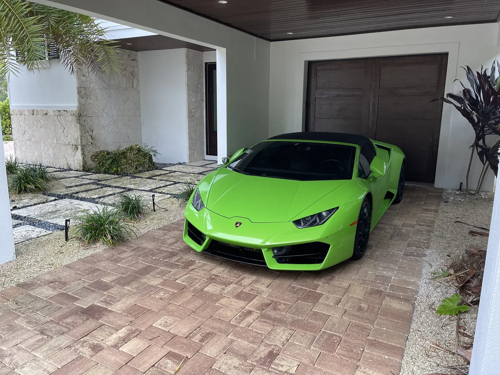 Green Lamborghini Huracán Spyder front three-quarter view with a glossy detailed finish