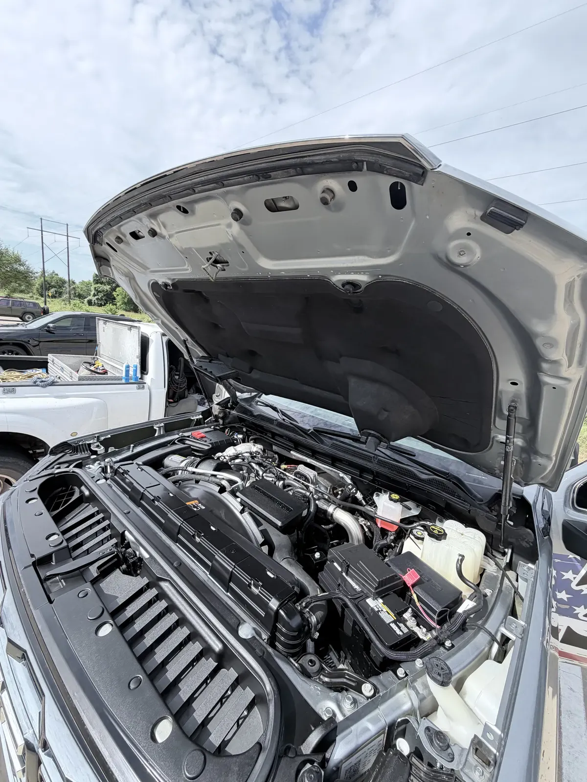 Clean, dressed engine bay on a heavy-duty pickup after engine bay detailing