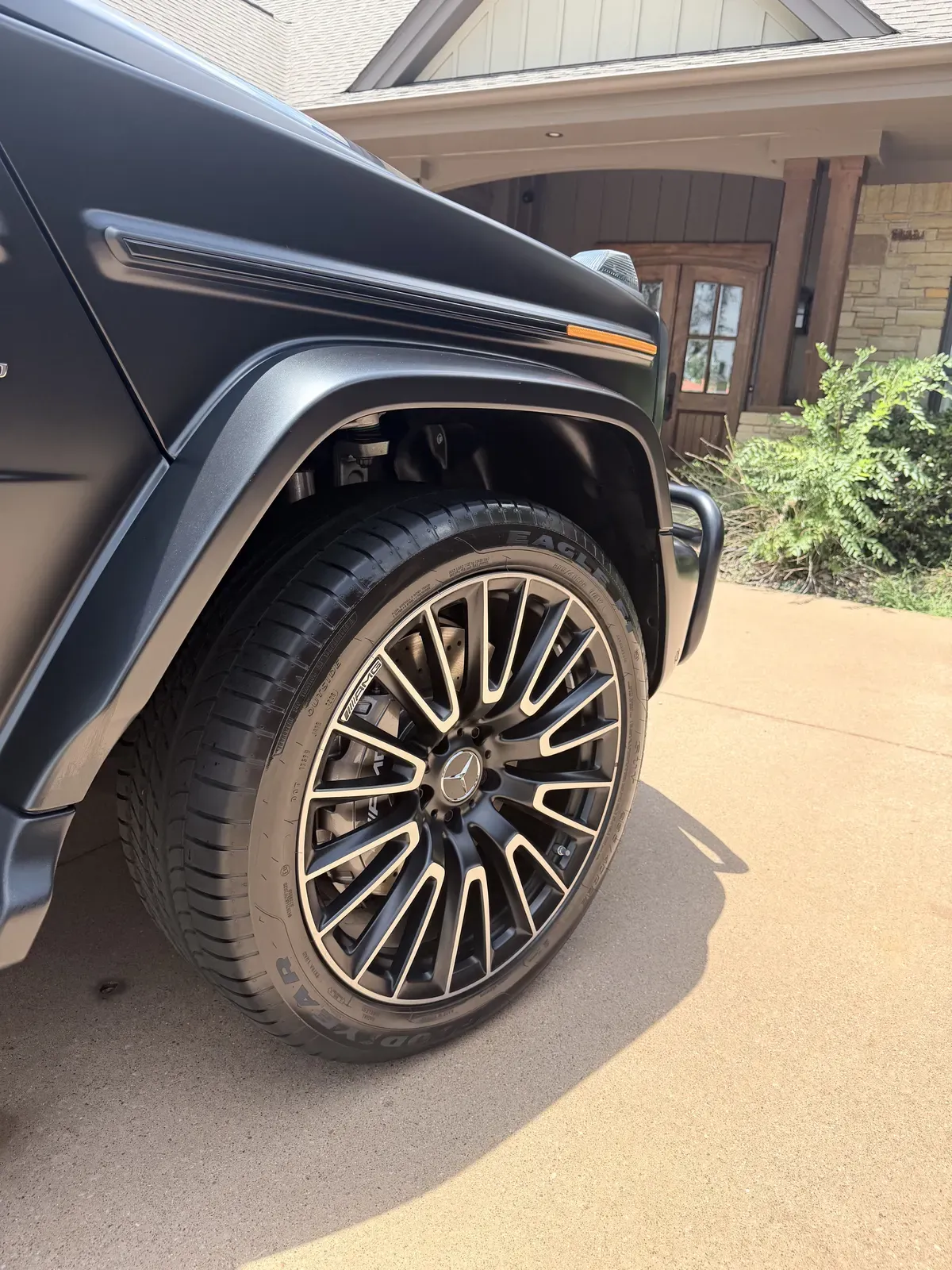 Cleaned and dressed wheel and tire on a matte black Mercedes-AMG G-Class