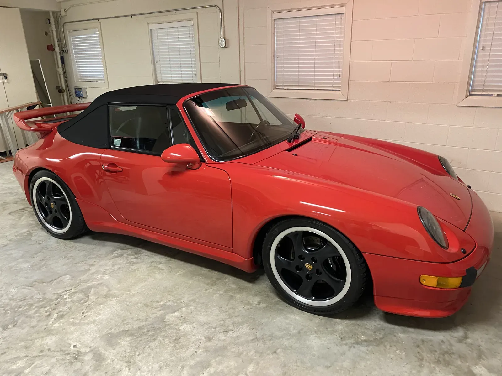 Red Porsche 911 993 cabriolet with a glossy detailed finish