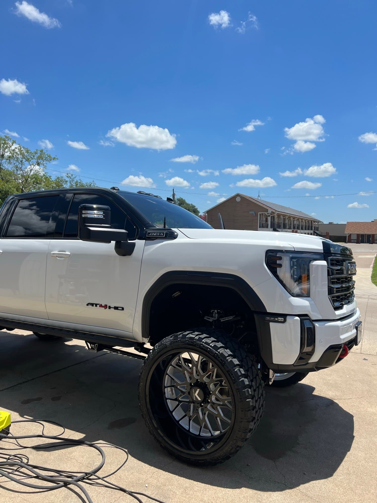 Detailed white GMC AT4 HD truck with gleaming finish